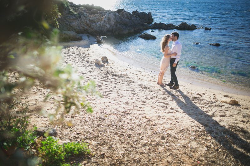 Couple celebrating their Antibes Seaside proposal at sunset on the beach 