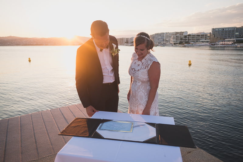 Emotional seaside elopement captured at dusk in Antibes, with pastel skies and gentle waves