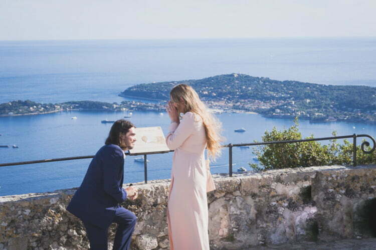 Romantic proposal at the Exotic Garden in Èze, photographed by Wild Roses Studio, capturing the couple’s joyful engagement with the Côte d’Azur coastline in the background.