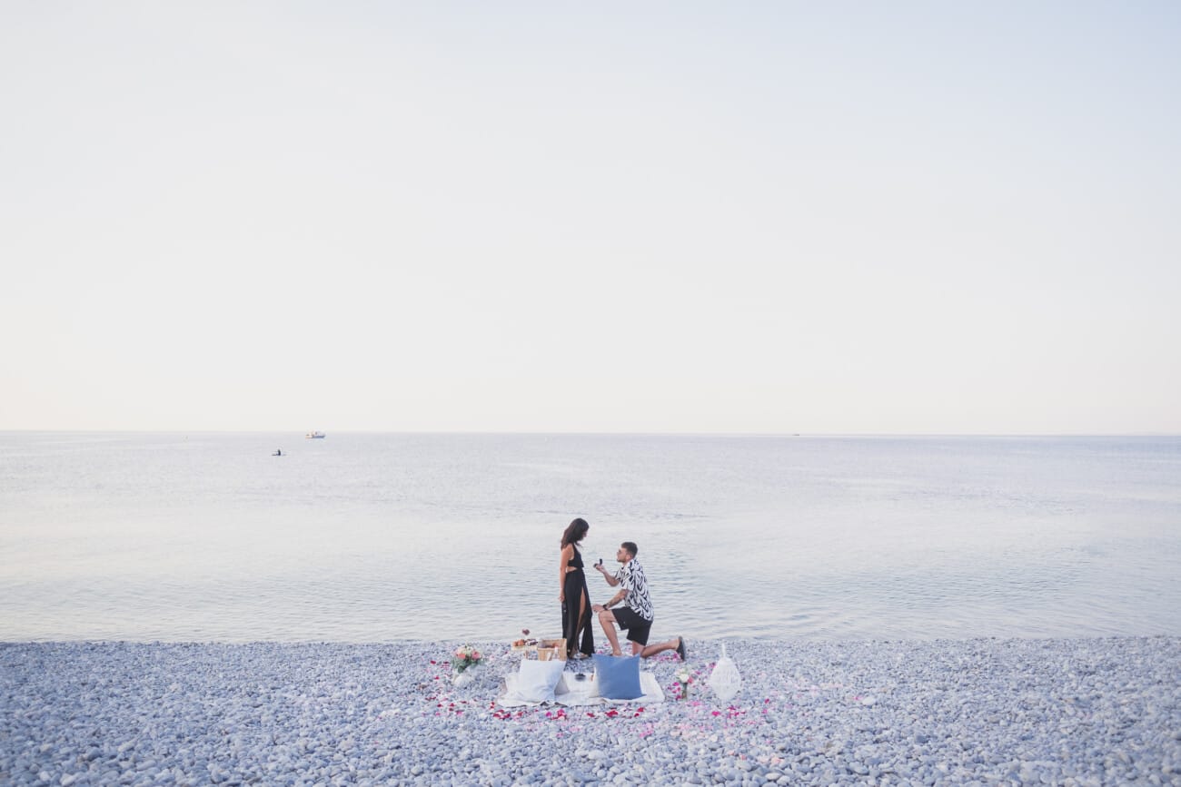 Nice early intimate morning breakfast proposal on the beach, no crow around them.