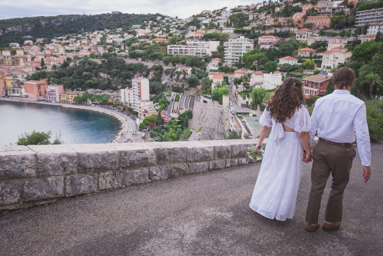 couple walking seaside path during Villefranche-sur-Mer elopement