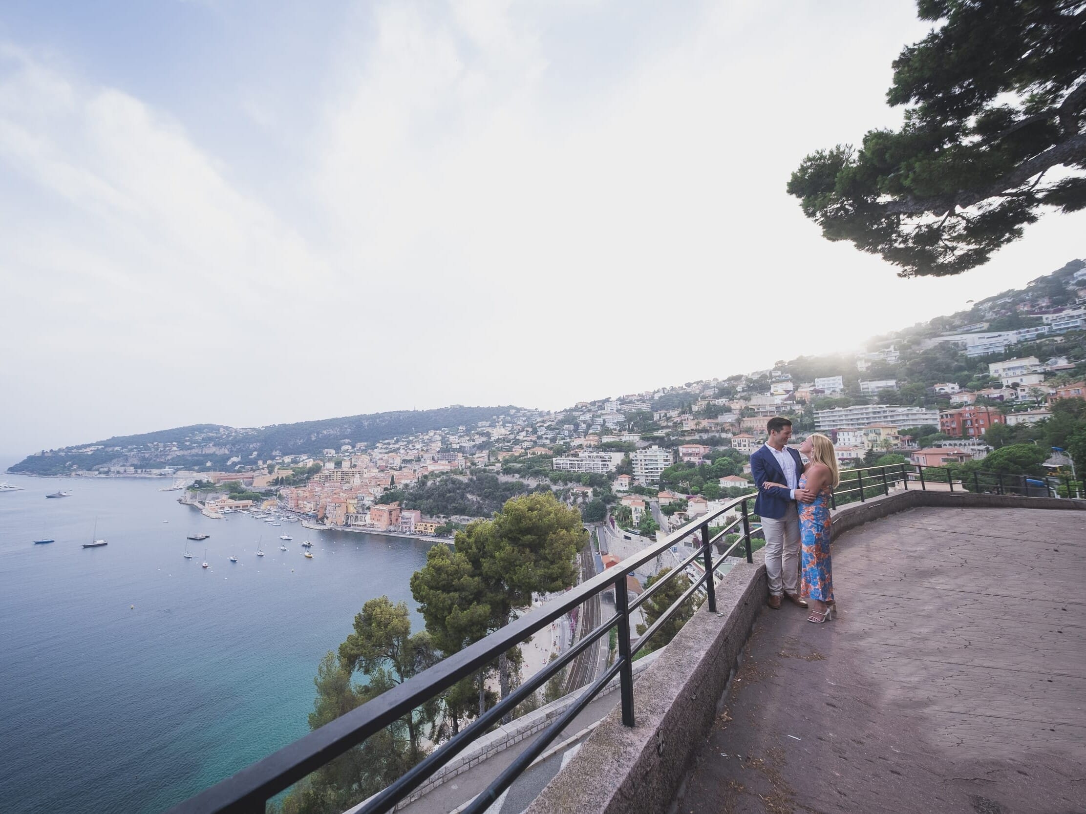 Proposal couple overlooking beautiful seaside town of VilleFranche-sur-Mer