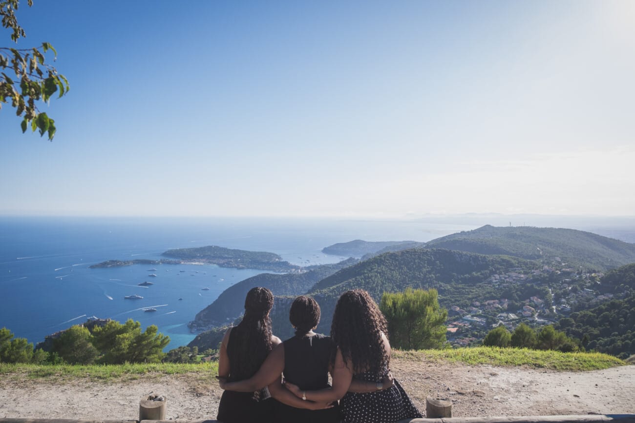 The Ultimate Girls’ Trip: A Mother and Daughters’ Legacy Session on the French Riviera 11 Mother and two daughters standing on a cliffside overlooking the Mediterranean Sea and Saint-Jean-Cap-Ferrat at sunset.