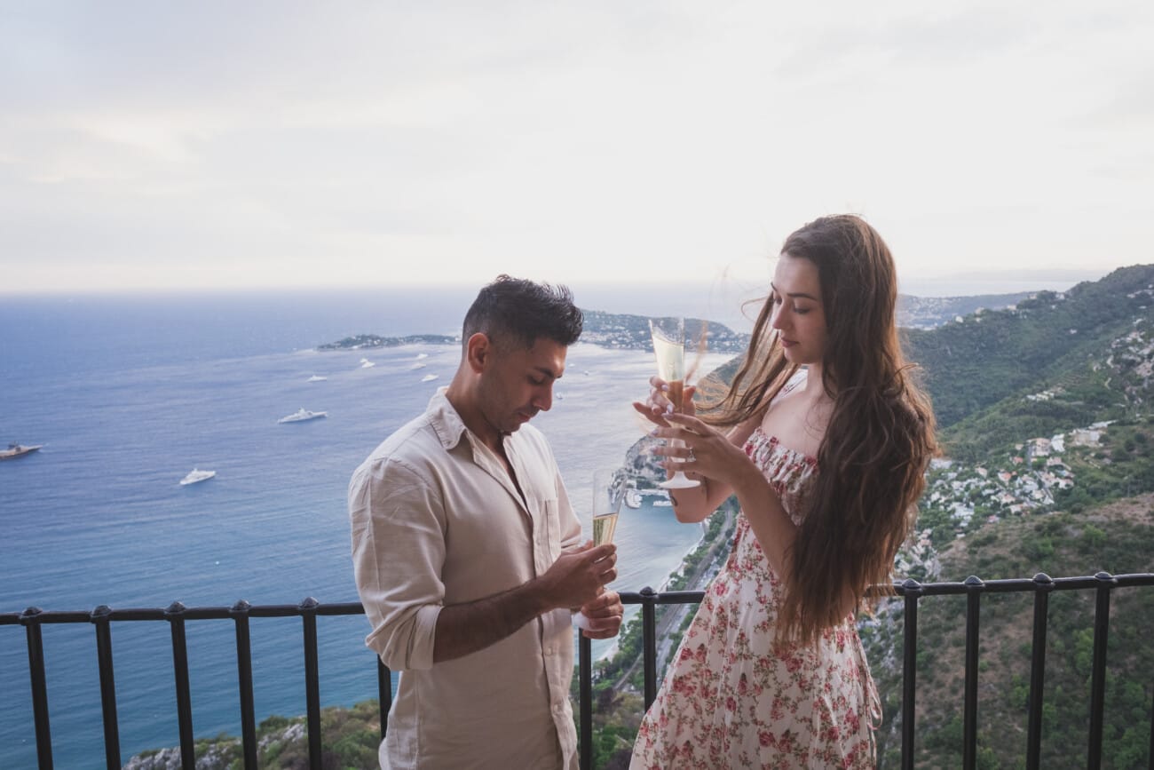 The couple toasting with champagne inside the Château Eza restaurant to celebrate their engagement.